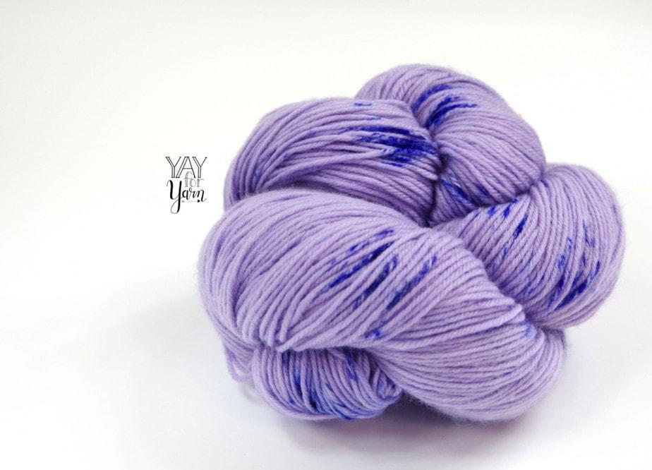 Purple hand-dyed fingering weight yarn with royal blue speckles