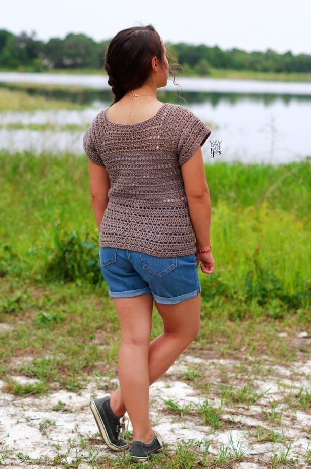 girl wearing crochet tee in front of lake