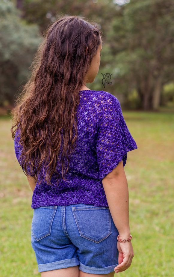 back view of ultraviolet lace knit tee, shown with white tank and jean shorts