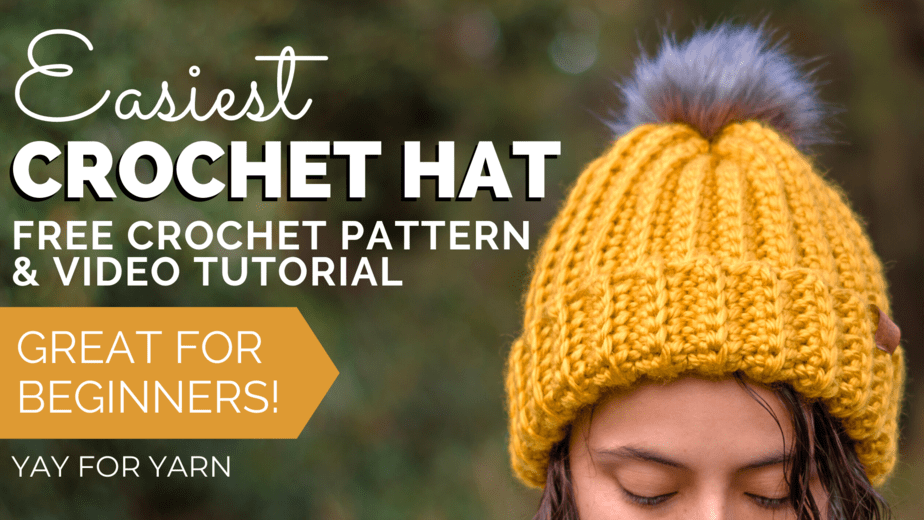 close-up of a girl outdoors wearing yellow crochet ski hat with gray fur pom pom with text “Easiest Crochet Hat, Free Crochet Pattern and Video Tutorial, Great for Beginners I Yay for Yarn”