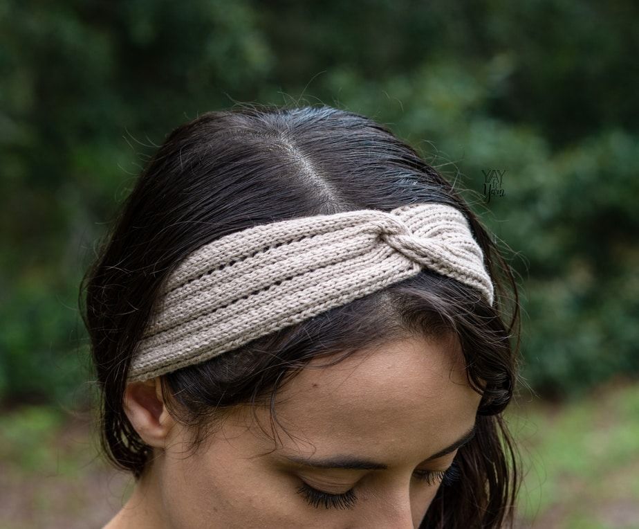 front / side view of twisted knit headband with eyelets