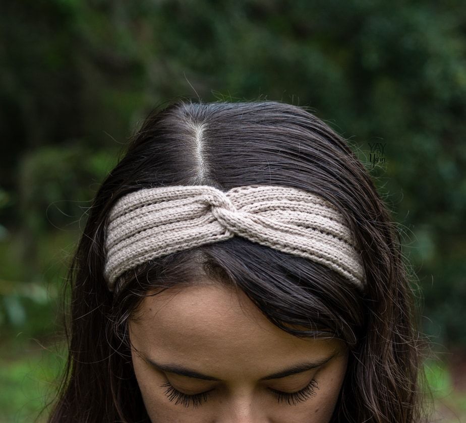 front view of twisted knit headband with eyelets