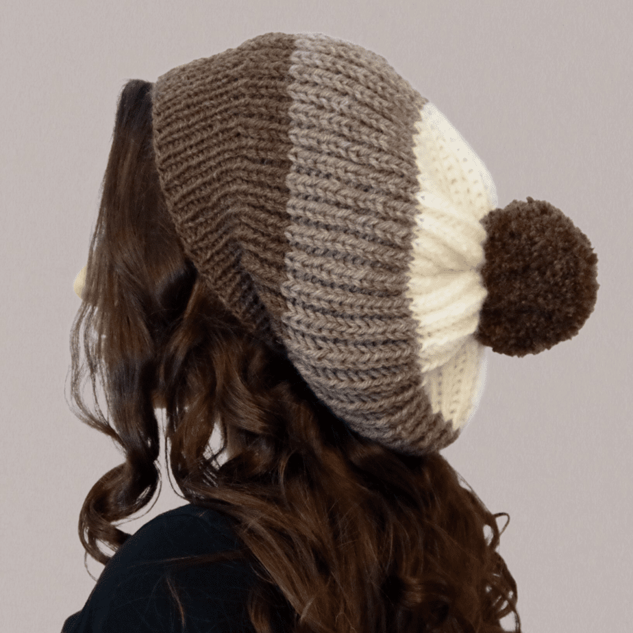 A side-view of a girl wearing a shortcut brioche slouchy hat