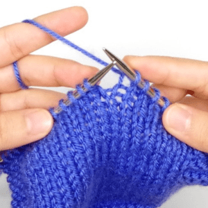 hands holding yarn and knitting needles continental style