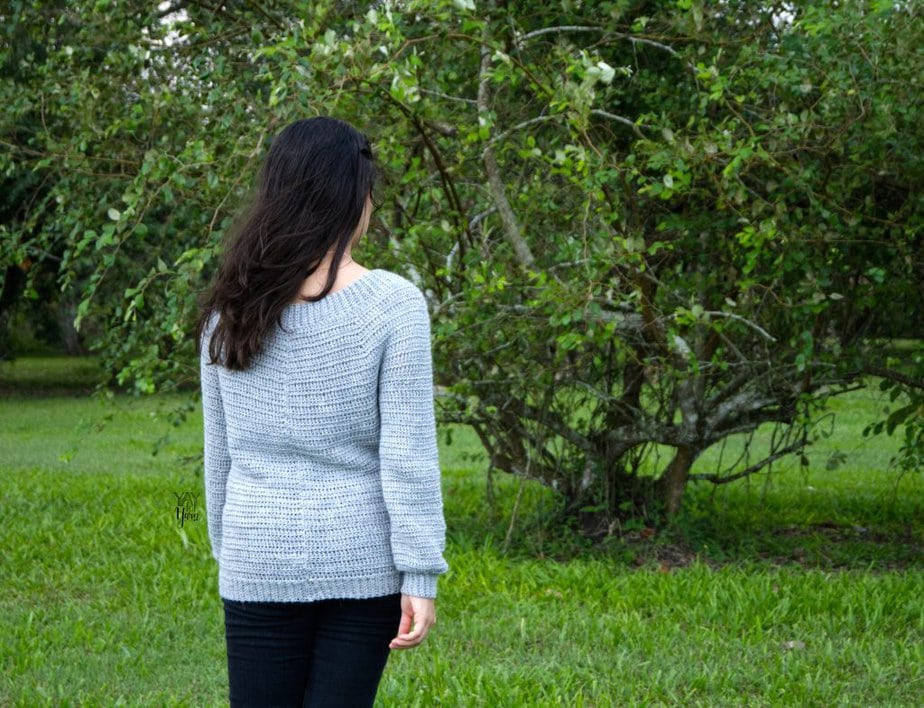 back view of light grey crochet sweater with long sleeves